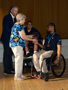 Martrell receiving 2025 Person of the Year Award from XX Kane.